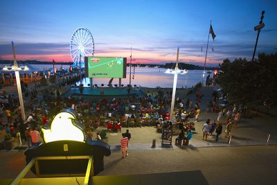 National Harbor paints their soy-backed SYNLawn for special events where guests gather to view sports and more on the big screen near the SYNLawn. Photo credit: National Harbor │Peterson Companies